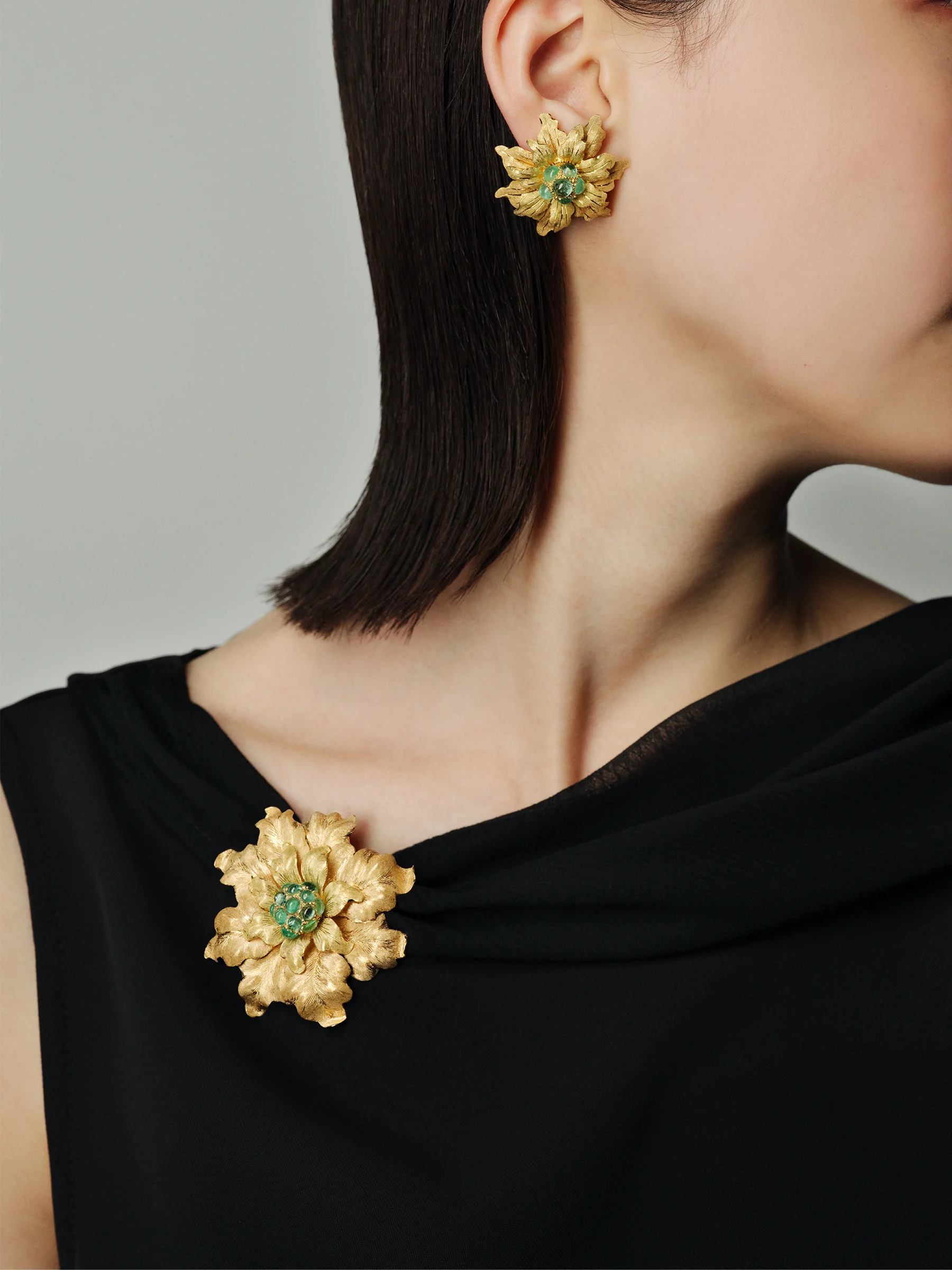 「フローラル ビューティ」ブローチ〈エメラルド、イエローゴールド〉イヤリング〈エメラルド、イエローゴールド〉（ミュージアムピースとしての展示品。販売不可）／ブチェラッティ　トップス／スタイリスト私物